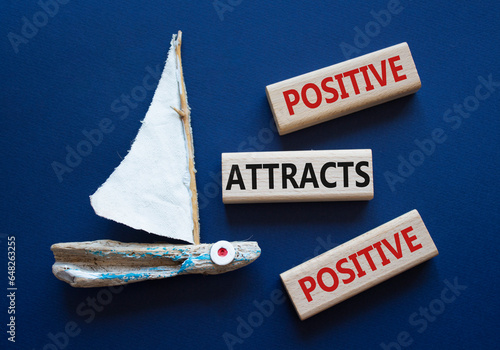 Positive attracts Positive symbol. Wooden blocks with words Positive attracts Positive. Beautiful deep blue background with boat. Business and Positive attracts Positive concept. Copy space. photo