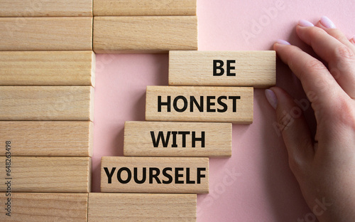 Be honest with Yourself symbol. Wooden blocks with words Be honest with Yourself. Businessman hand. Beautiful pink background. Be honest with Yourself concept. Copy space. photo