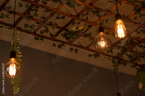 Obraz na płótnie A modern lamp made of a wooden lattice, decorated with plants. Modern design w salonie