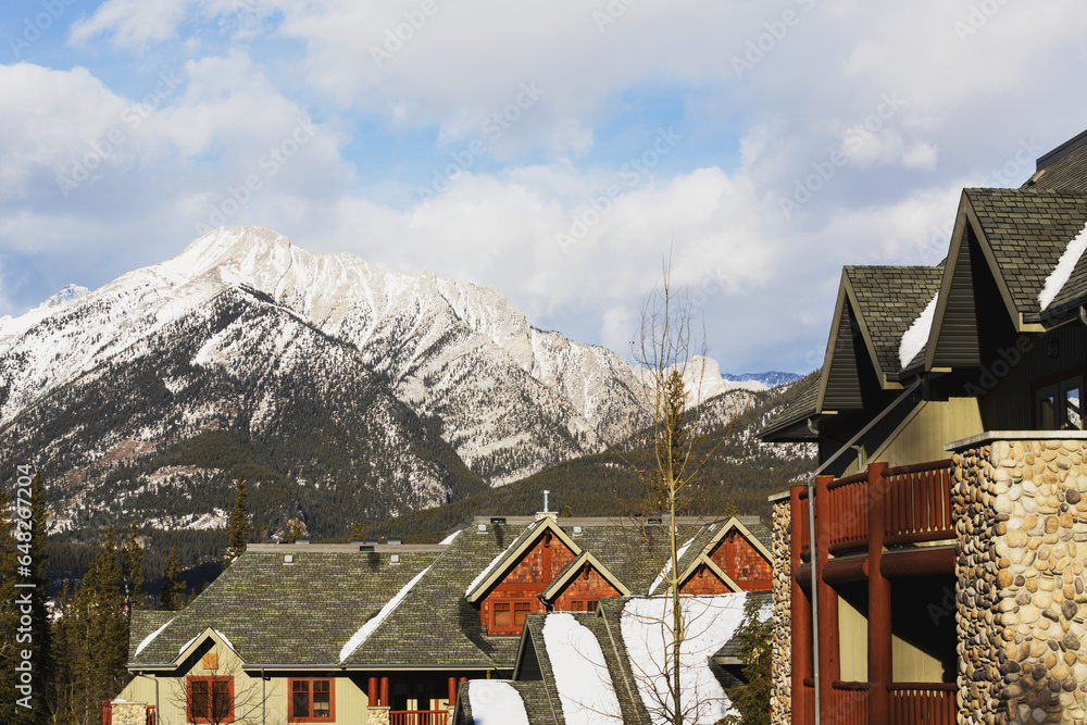 View Of Mountains Over Residential Buildings; Canmore, Alberta, Canada View Of Mountains Over Residential Buildings; Canmore, Alberta, Canada