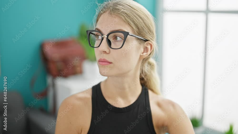 Young blonde woman business worker using computer looking watch at the office Young blonde woman business worker using computer looking watch at the office