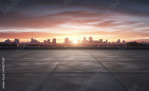 a beautiful sunset over a city from an asphalt parking lot with a city view