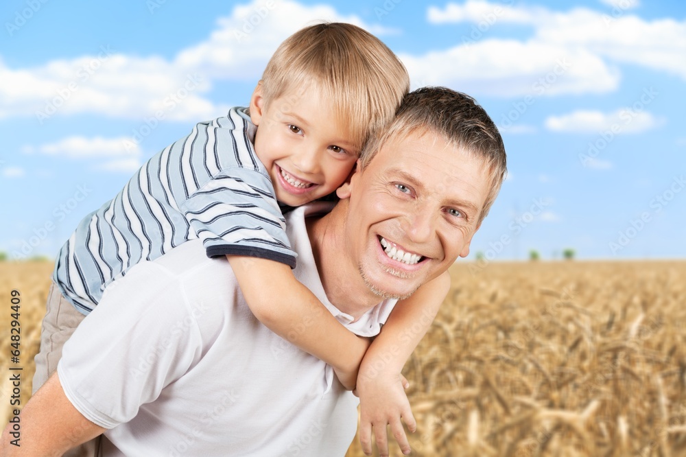 Portrait of young happy father with child in park Portrait of young happy father with child in park