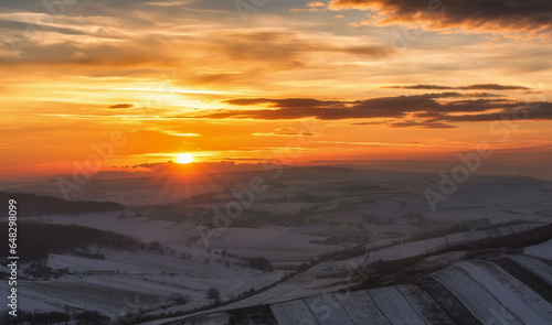 Sunset over countryside panorama during winter 
