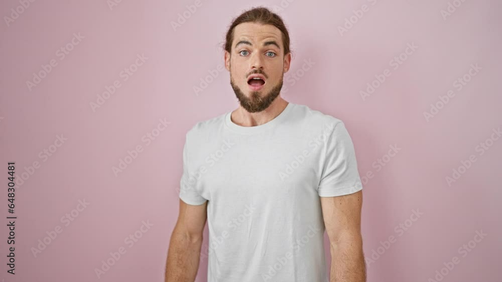 Young hispanic man standing with surprise expression over isolated pink background Young hispanic man standing with surprise expression over isolated pink background