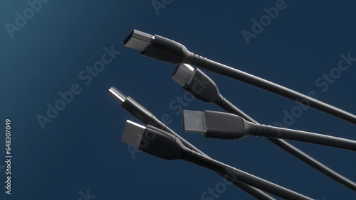 HDMI cables spinning on dark blue background. Close-up view of the plug in high definition. HDMI connectors for computer video. Multimedia interface. Equipment.