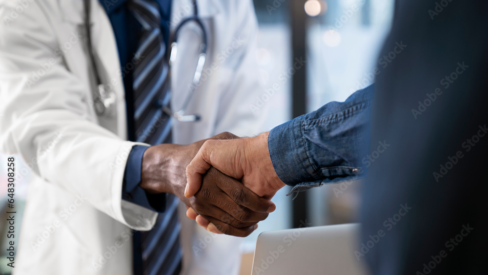 Doctor shakes hands with a patientd patient are at clinic Doctor shakes hands with a patientd patient are at clinic