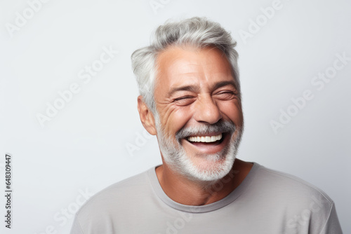 A closeup photo portrait of a beautiful elderly senior old mature model man grey hair laughing and smiling. morning skin care routine cosmetics. isolated on white background.