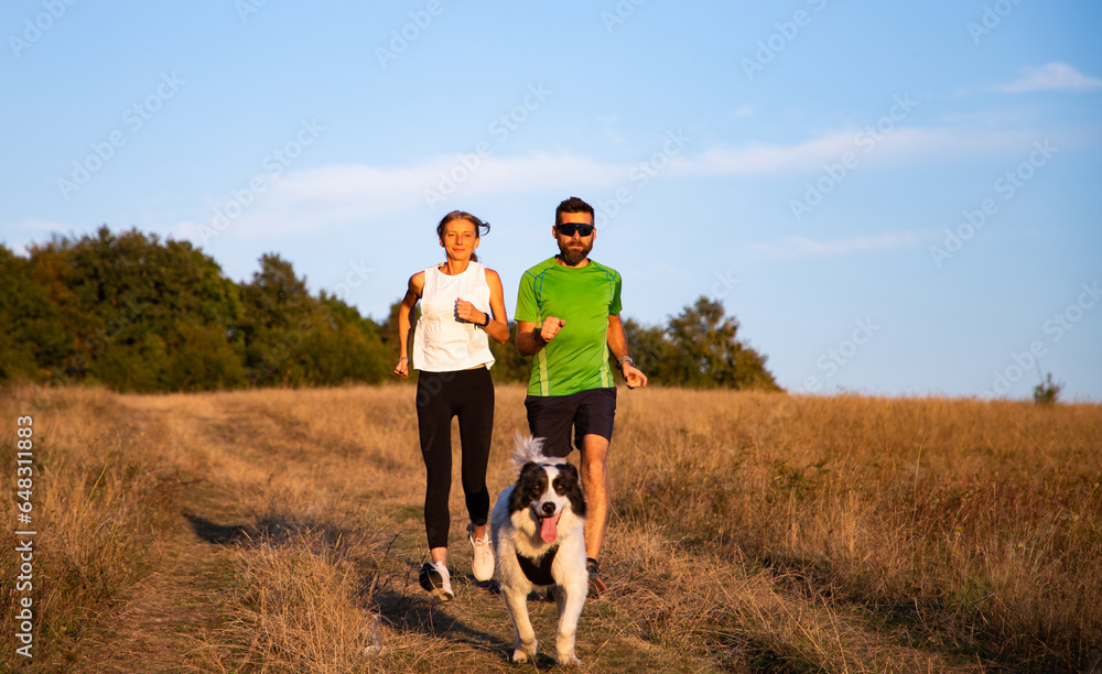 fit couple running with dog fit couple running with dog