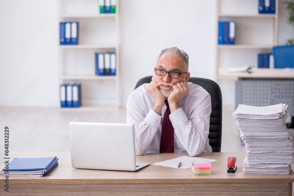 Old male employee and too much work in the office Old male employee and too much work in the office
