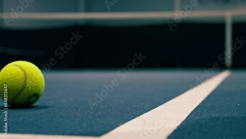 close-up of white marking lines on indoor blue tennis court ball rolling sports equipment game hobby competition