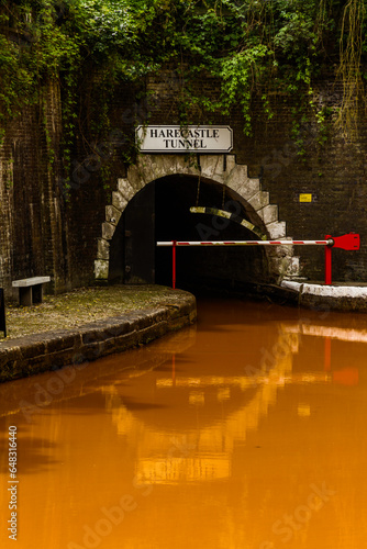 Orange coloured canal with northern entrance to the Harecastle Tunnel, The Trent and Mersey Canal. photo
