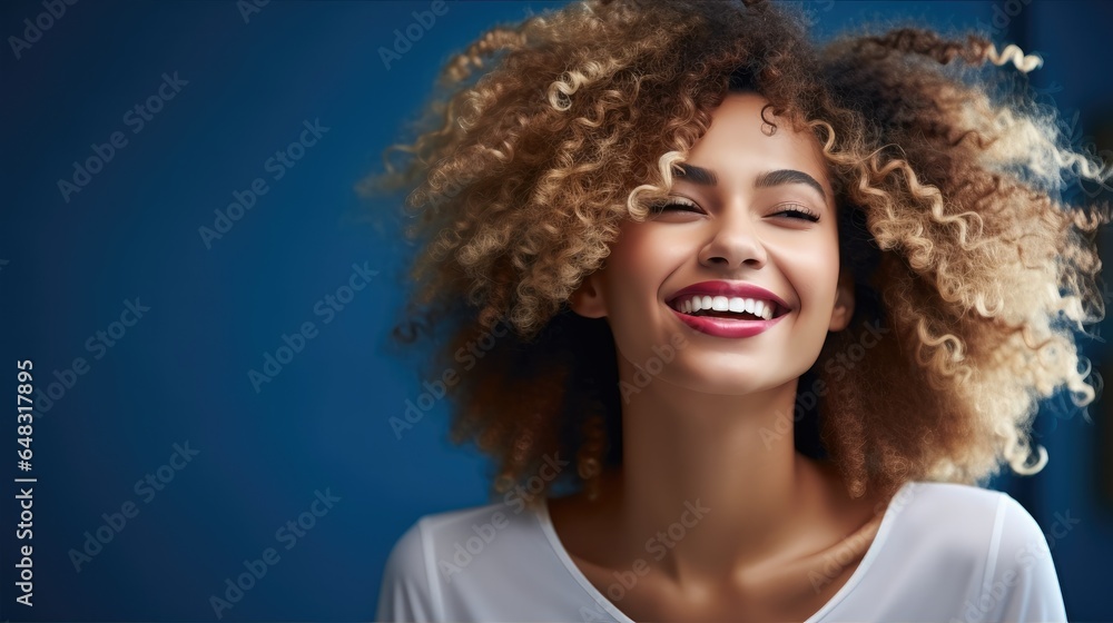 Fototapeta premium Happy active African American woman on blue background.