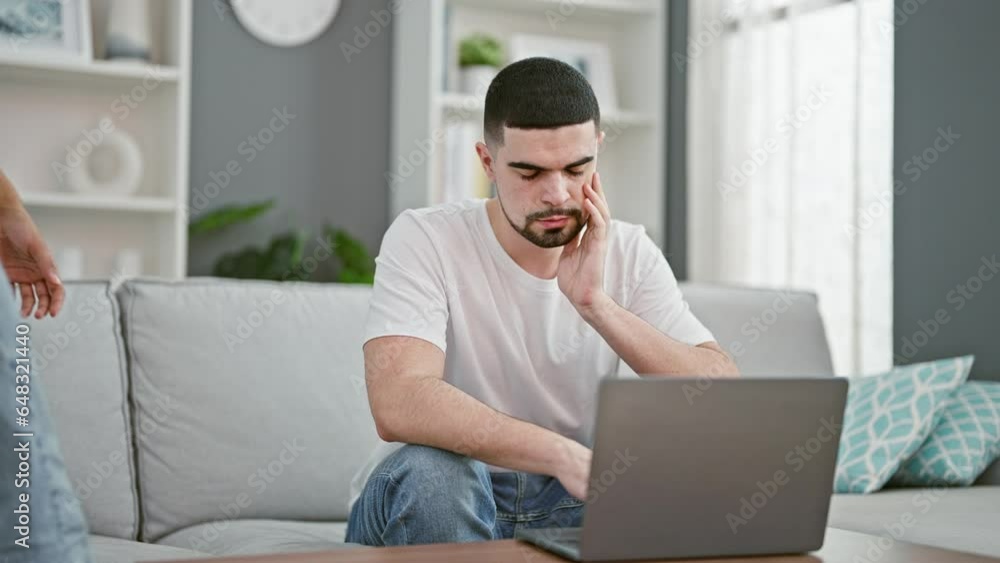Beautiful couple in love, sitting together on a sofa at home, using a laptop in a focused, concentrated manner. they share a kiss, supporting each other in a serious online task. Beautiful couple in love, sitting together on a sofa at home, using a laptop in a focused, concentrated manner. they share a kiss, supporting each other in a serious online task.