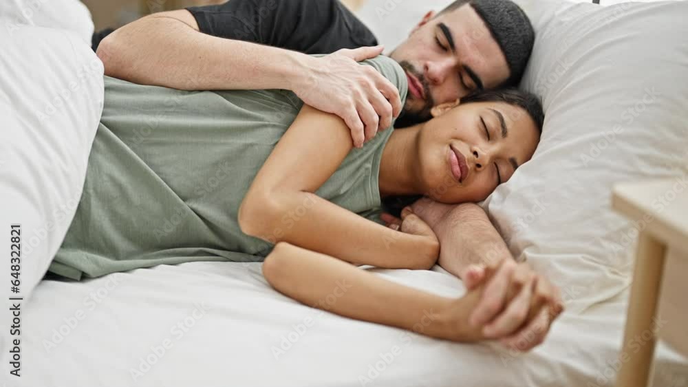 Beautiful couple in love, lying together in bed, hugging while asleep in their cozy bedroom, enjoying the comfort of relaxation and rest while expressing their family bonds Beautiful couple in love, lying together in bed, hugging while asleep in their cozy bedroom, enjoying the comfort of relaxation and rest while expressing their family bonds