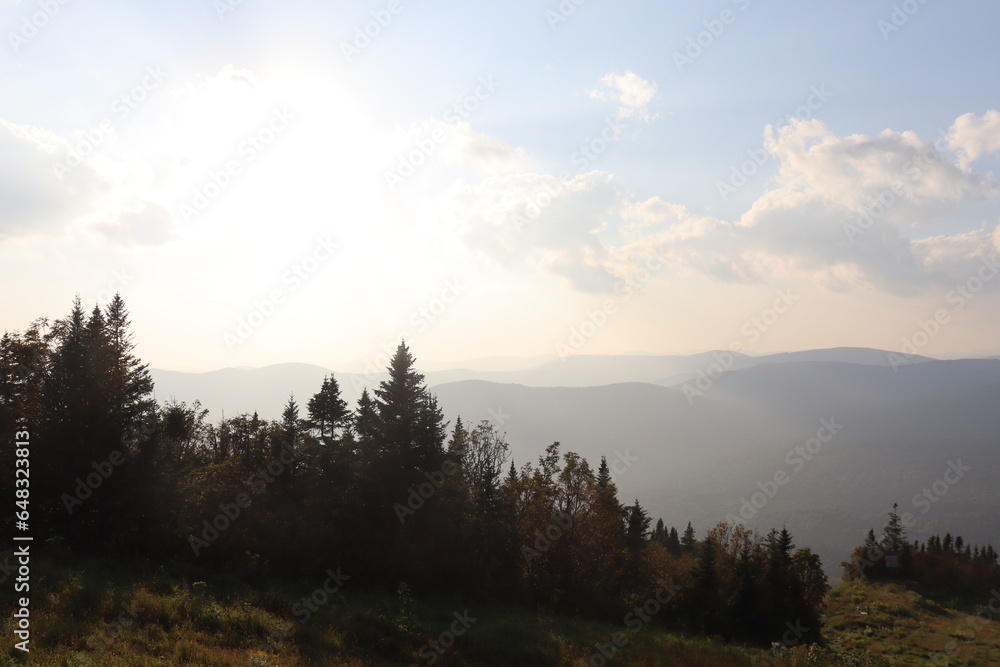 Autumn landscape with a beautiful cloudy sky, trees and mountains. Autumn background and the nature in Canada. Outdoors activities and hiking trail in the forest and in national park. Autumn landscape with a beautiful cloudy sky, trees and mountains. Autumn background and the nature in Canada. Outdoors activities and hiking trail in the forest and in national park.