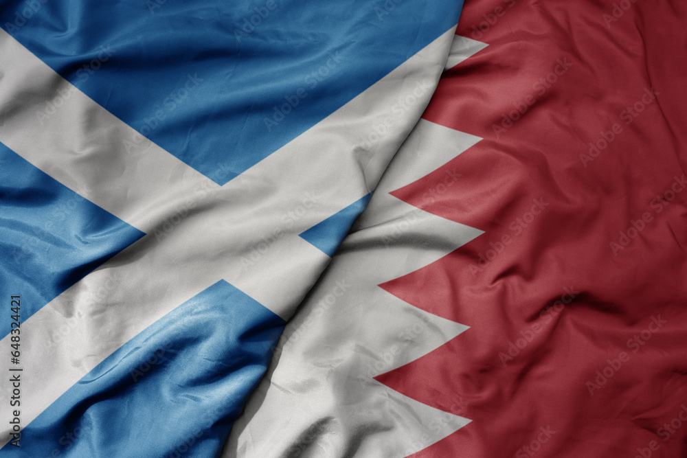 big waving national colorful flag of scotland and national flag of bahrain . big waving national colorful flag of scotland and national flag of bahrain .