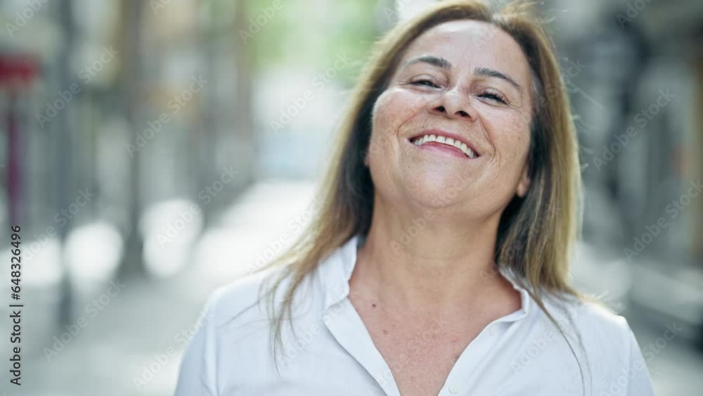 Middle age hispanic woman smiling confident standing at street Middle age hispanic woman smiling confident standing at street