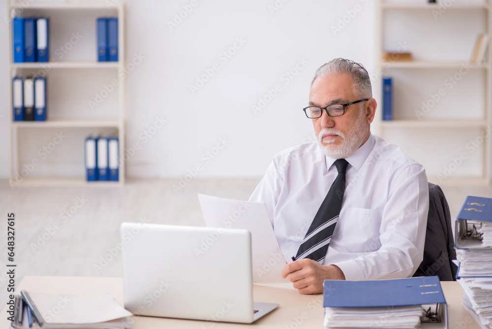 Old male employee and too much work in the office Old male employee and too much work in the office