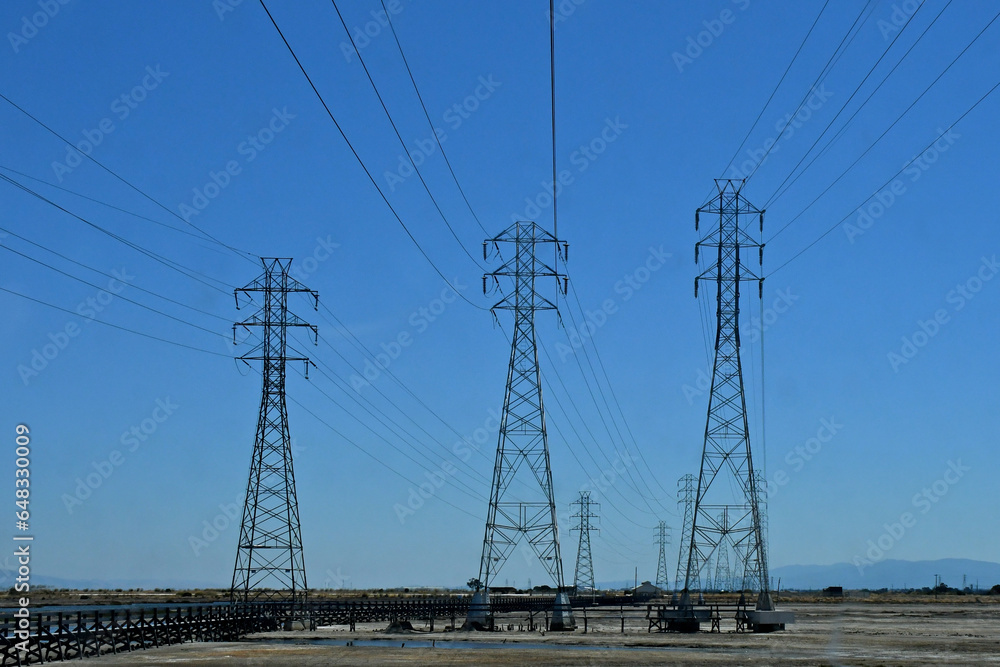 Three electrical transmission towers adjacent to San Francisco Bay