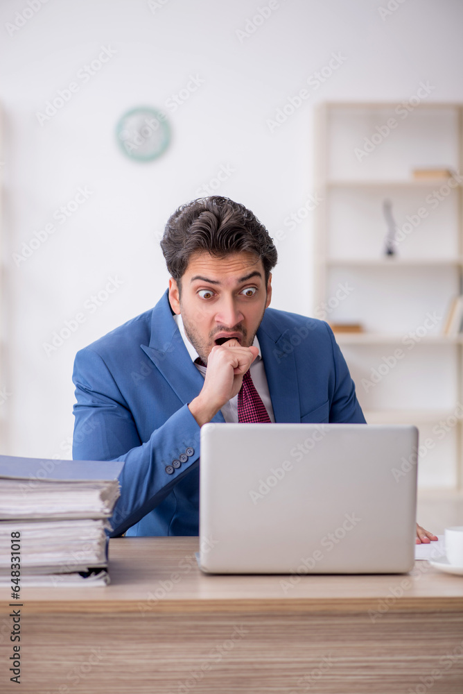Young male employee working in the office Young male employee working in the office