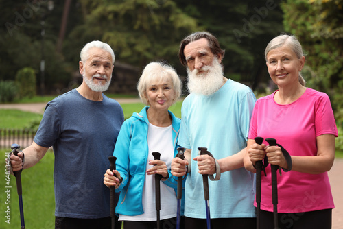 Group of senior people with Nordic walking poles outdoors