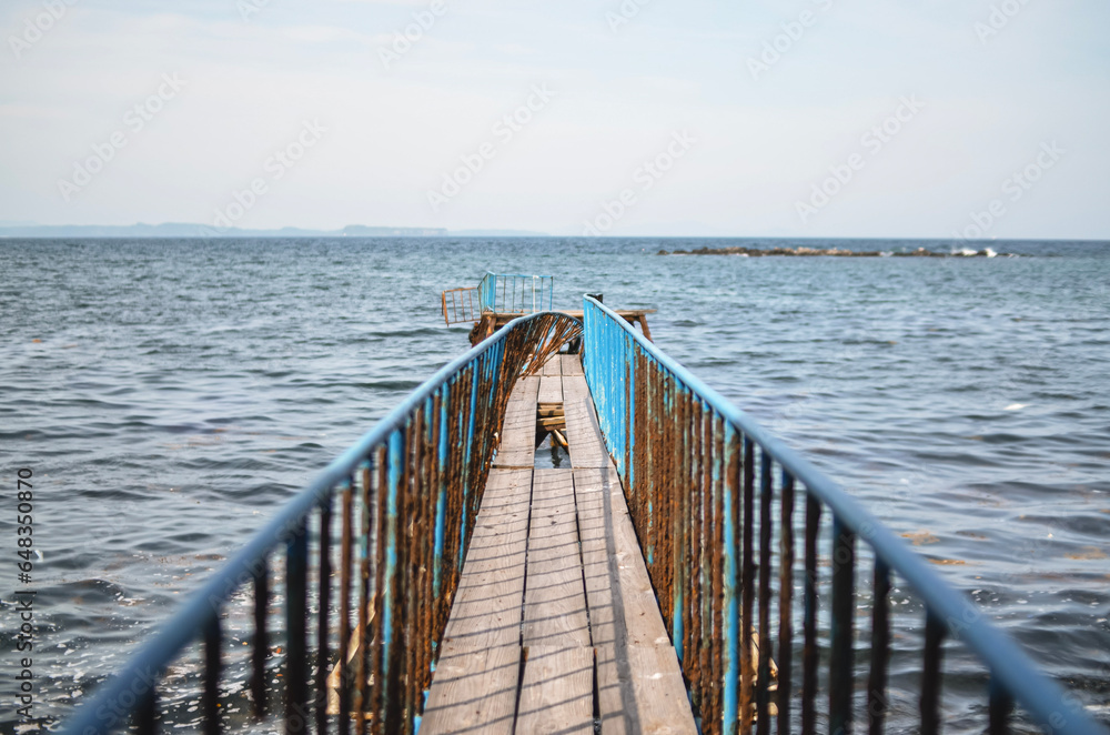 Naklejka premium The deserted iron road leads to the sea