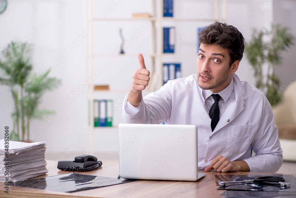 Young male doctor working in the clinic Young male doctor working in the clinic