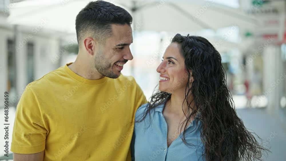 Man and woman couple smiling confident standing together at street Man and woman couple smiling confident standing together at street