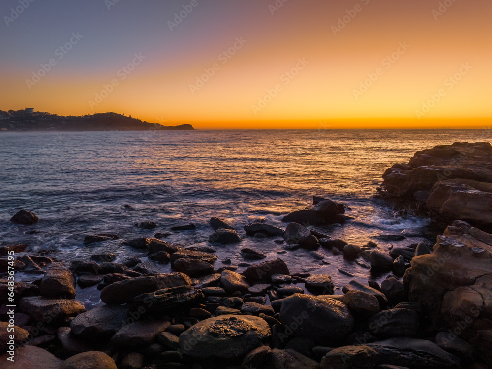 Sunrise over the ocean with orange horizon