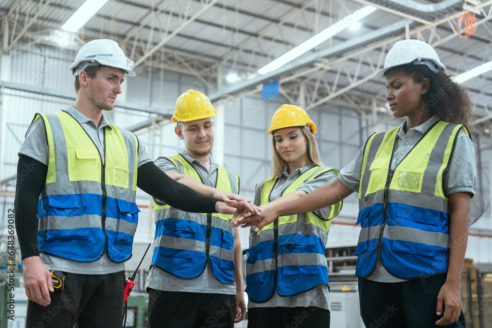 Group of technicians and employees in a paper mill holding hands and talking Collaborate with the team to work in the warehouse. Group of technicians and employees in a paper mill holding hands and talking Collaborate with the team to work in the warehouse.