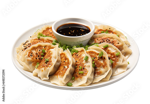 Pan-fried gyoza with dipping sauce on a white plate, isolated on white or transparent background. photo