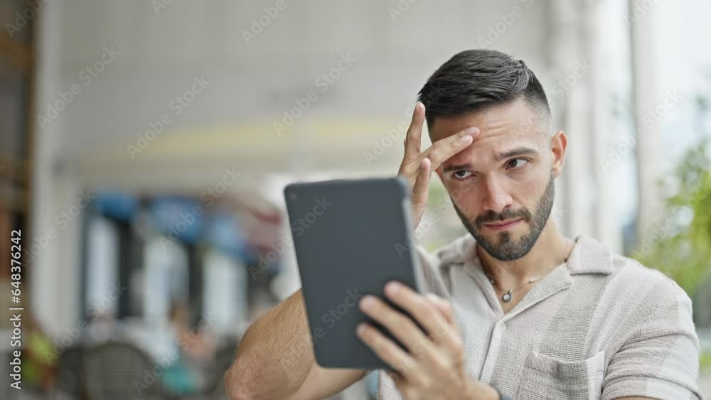 Young hispanic man smiling confident make selfie by touchpad at coffee shop terrace Young hispanic man smiling confident make selfie by touchpad at coffee shop terrace