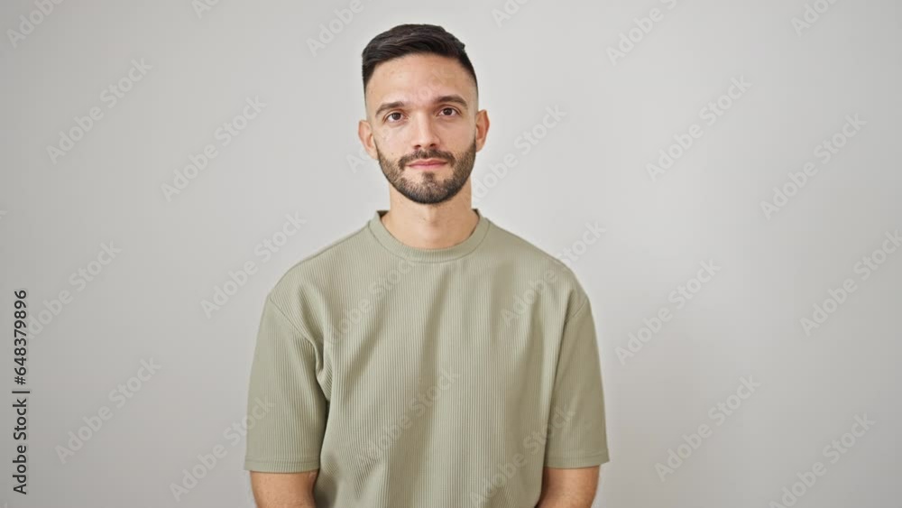 Young hispanic man standing with serious expression over isolated white background Young hispanic man standing with serious expression over isolated white background