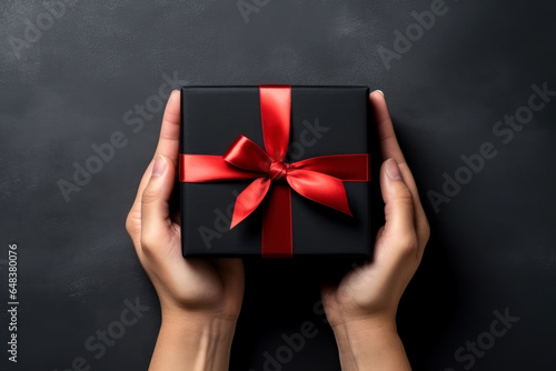 Hand hold black gift box 