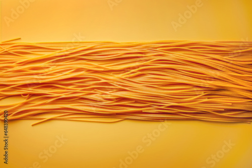 Strands of spaghetti pasta noodles stuck to a yellow background, throw spaghetti at the wall to see what sticks concept