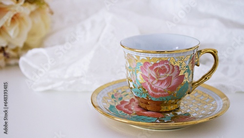 Antique cup of tea with pink rose on white background ,English tea vintage tone Valentine's day romantic ,Mother's day ,pretty background ,Chinese traditional ,coffee cup ,porcelain teacup 