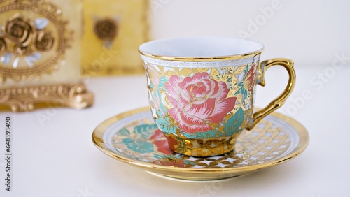 Antique cup of tea with pink rose on white background ,English tea vintage tone Valentine's day romantic ,Mother's day ,pretty background ,Chinese traditional ,coffee cup ,porcelain teacup 