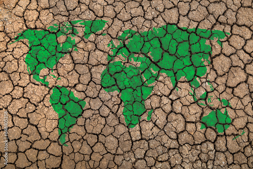 Green world map on drought cracked ground Ecology and environment concept.