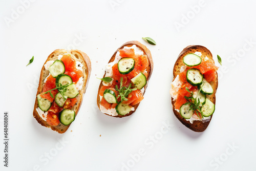 Bruschetta with salmon, curd cheese and cucumber on toast in high key style on white background, aesthetic look