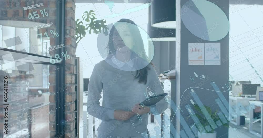 Data processing on interface over biracial casual businesswoman with tablet walking in office Data processing on interface over biracial casual businesswoman with tablet walking in office