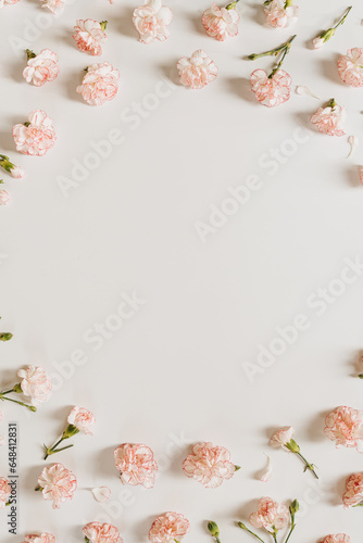 Minimal floral styled concept. Pink carnation flowers on white background with copy space. Creative wedding invitation template. Flat lay, top view