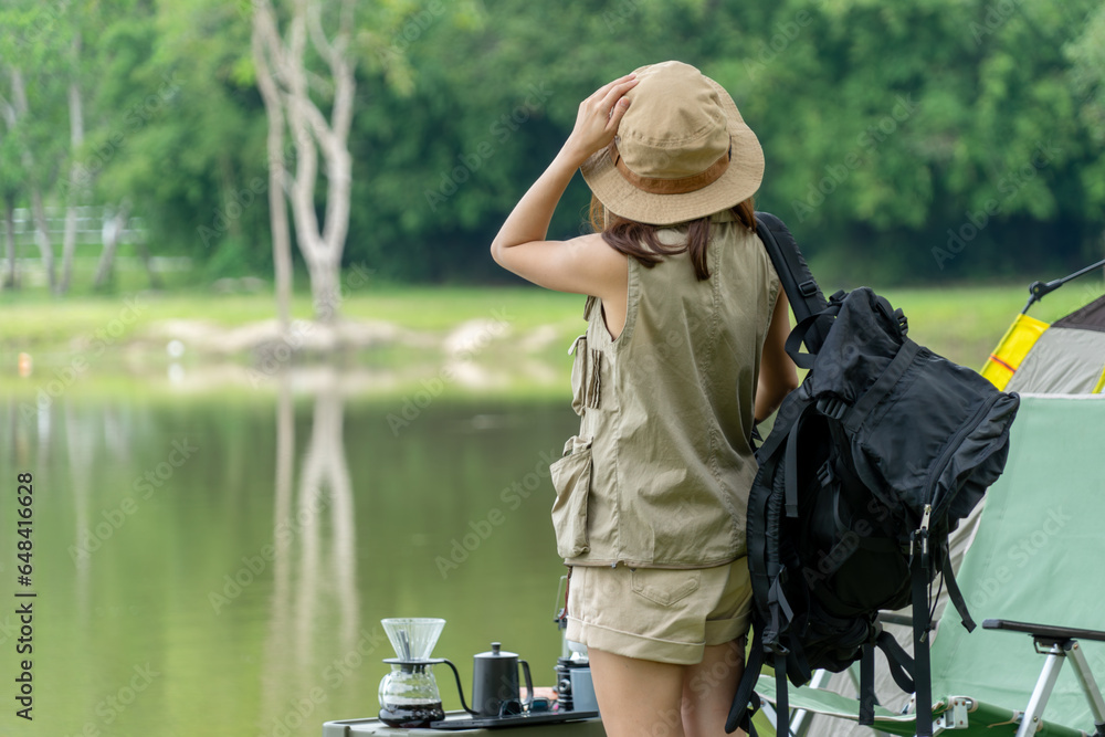 An Asian woman camper relaxing and enjoying camping alone.