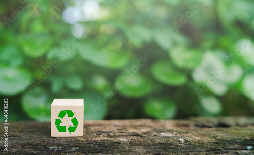 Wooden cube with environmentally friendly recycling icon Concept of green business and sustainable development Earth Day.