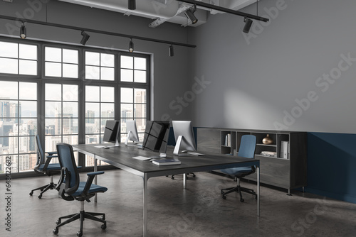 Photography Dark office interior with pc monitors and sideboard, window