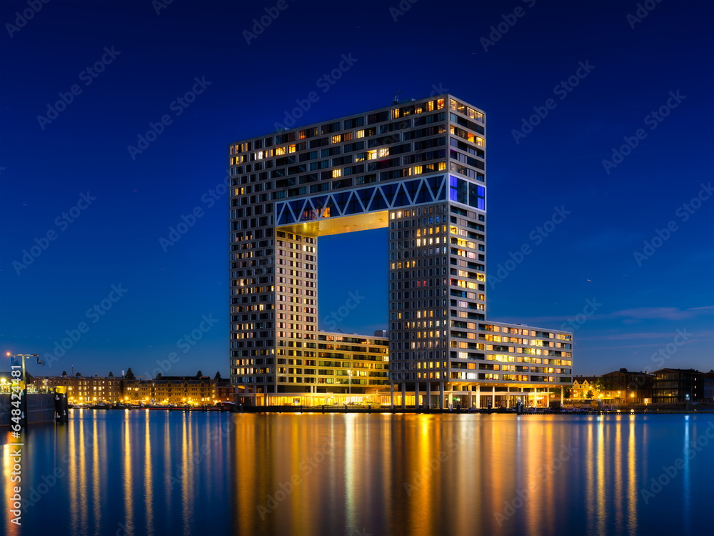 Amsterdam, Netherlands. A cityscape in the evening. A skyscraper and business center near the water in the bay. Architecture of the Netherlands. Travel photography.