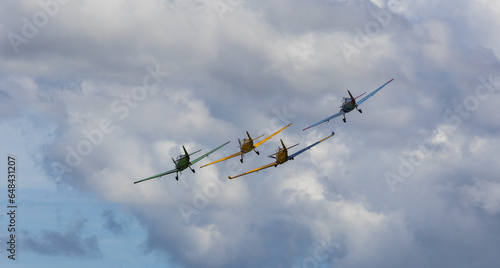 Four acrobatic plane flying on cloudy sky with mountain. Aviation  sport background