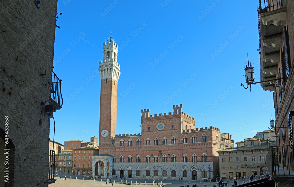 Obraz premium Siena, SI, Italy - February 20, 2023: Town Hall called PALAZZO PUBBLICO and Tower TORRE DEL MANGIA in main square