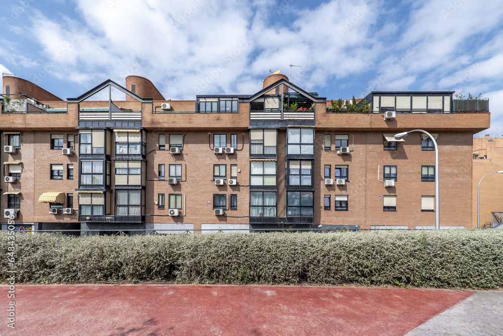 Facades of residential buildings with homes in the attics and black aluminum and glass metal closures