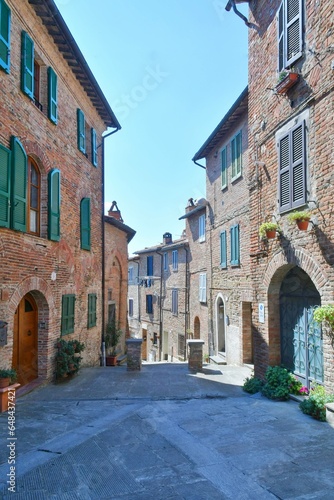 Fototapeta Naklejka Na Ścianę i Meble -  A street between the houses of Città della Pieve, a medieval village in Umbria, Italy.
